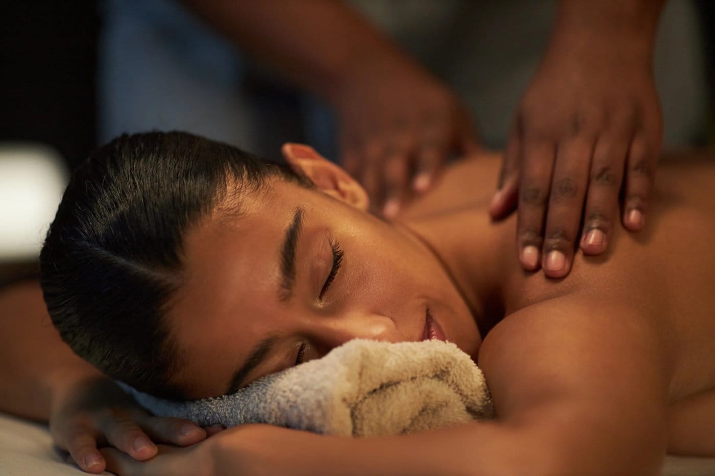 Guest lying face down receiving a relaxing back facial massage at the spa